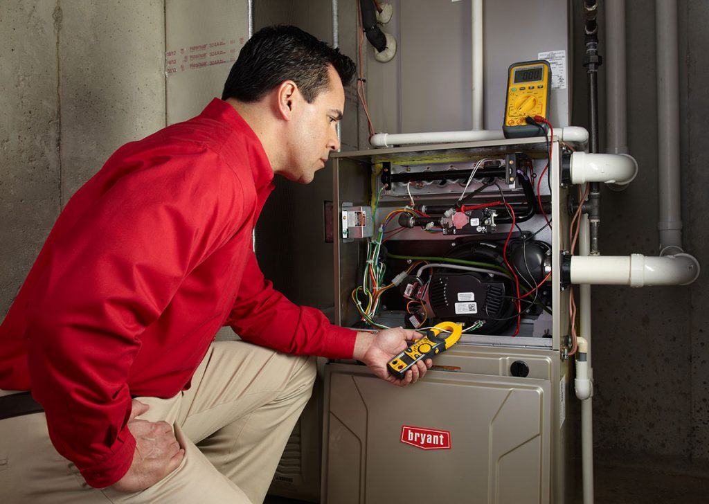 HVAC technician repairing an indoor furnace in Commerce City