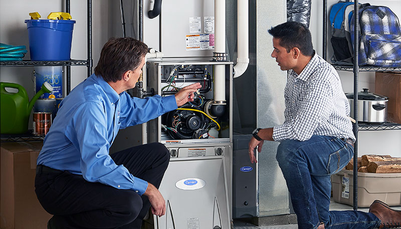 HVAC technician evaluating a furnace for repair or replacement in Commerce City