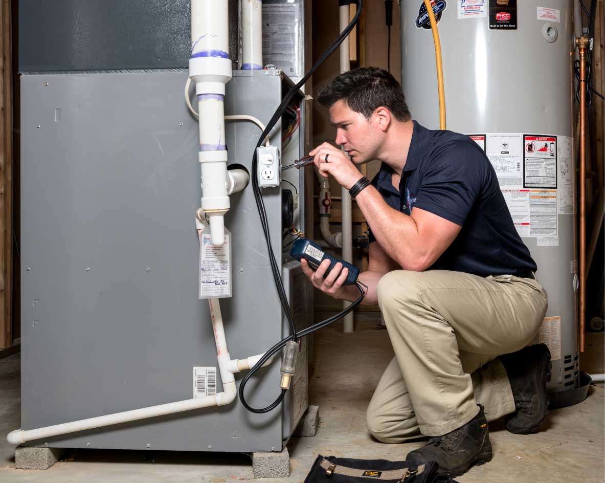 HVAC technician performing a furnace tune-up in Commerce City