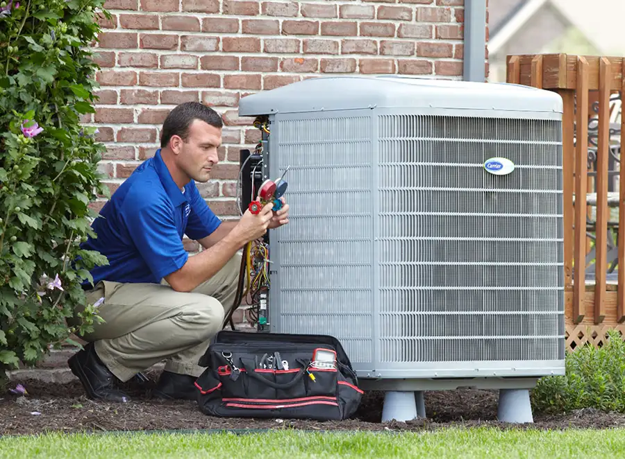 HVAC technician inspecting an outdoor air conditioning unit in Commerce City