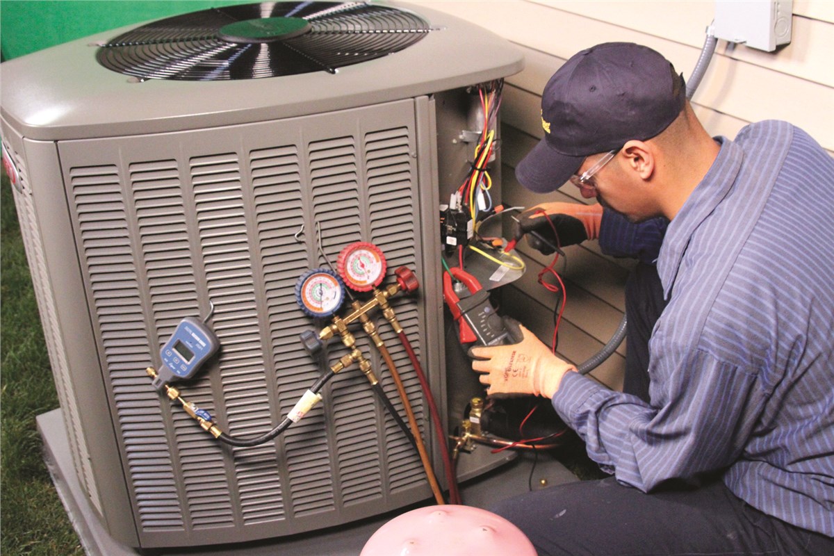 HVAC technician testing an outdoor air conditioning unit in Commerce City